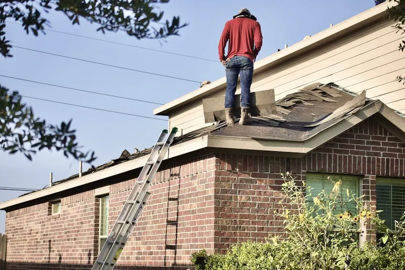Professional roofer working on a residential roof in Caddo Mills
